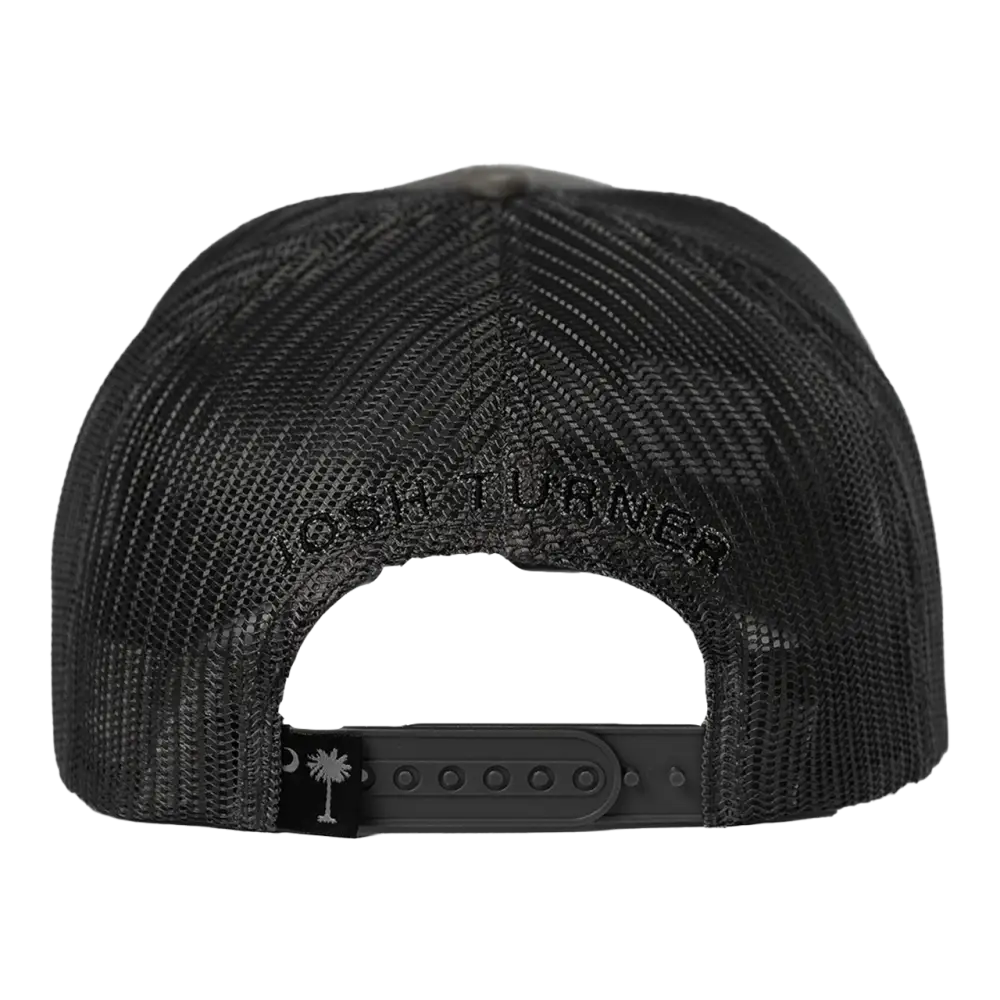Black mesh trucker hat with ’josh turner’ embroidered across the back and a small south carolina palmetto tree logo on the adjustable strap.
