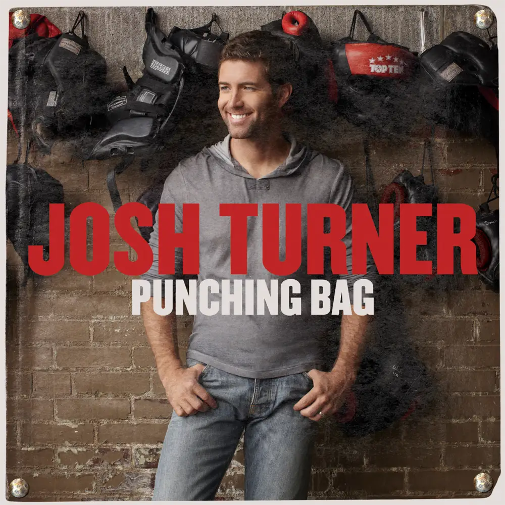 Album cover featuring a smiling man in casual clothing with boxing equipment in the background.
