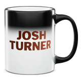 Coffee mug with ’JOSH TURNER’ printed on it in brown lettering against a black-to-white gradient background.