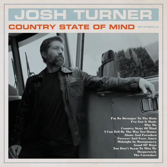 Josh turner’s ’country state of mind’ album cover features a black-and-white photograph of him leaning against the side of a truck, wearing a dark leather jacket.