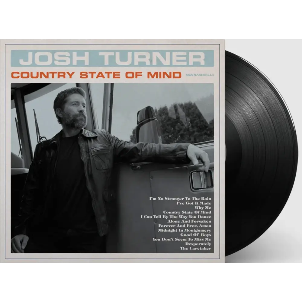 Black vinyl record with a glossy finish, partially visible beside the album cover.