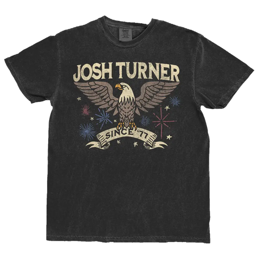 Black distressed cotton t-shirt featuring a vintage-style graphic of an eagle with ’josh turner’ and ’since ’77’’ printed above and below in cream-colored lettering.