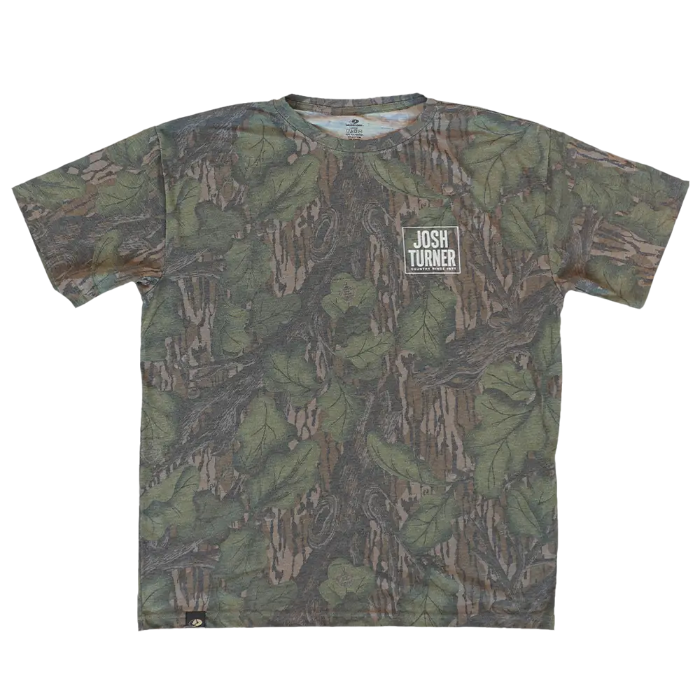 A josh turner camouflage t-shirt featuring a detailed leaf and branch pattern in shades of green, brown, and beige.
