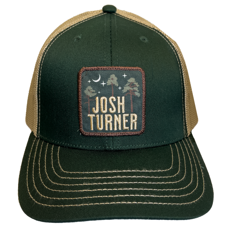 Trucker-style baseball cap with a dark green front, tan mesh back, and a square patch featuring the name ’Josh Turner’.