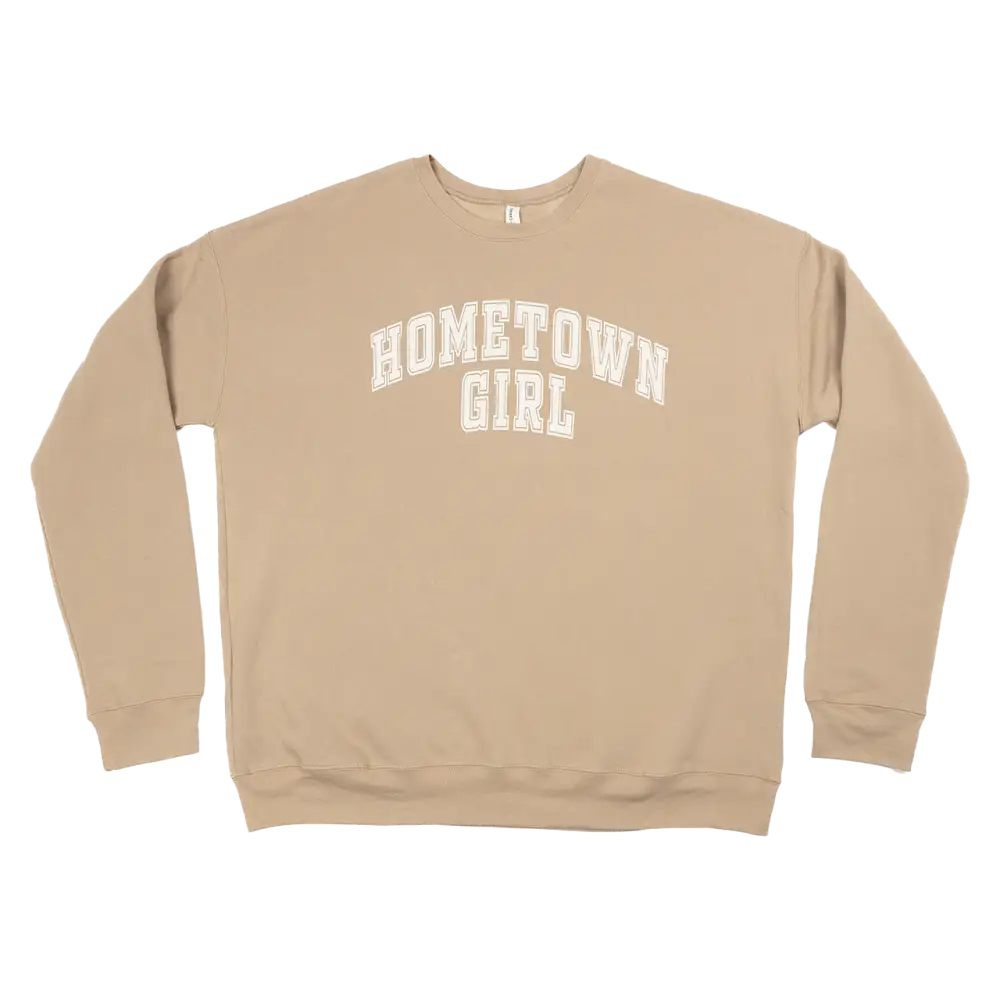 Beige sweatshirt with ’HOMETOWN GIRL’ printed in white text on the front.