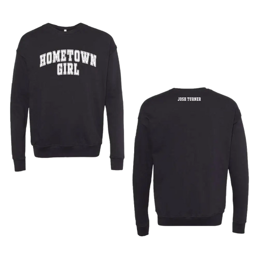 Black long-sleeved sweatshirt with ’hometown girl’ in white arched lettering across the chest and ’josh turner’ printed on the back.