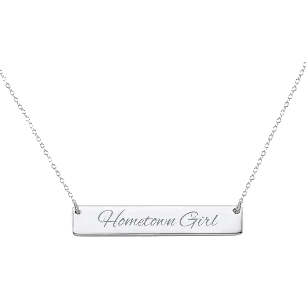 Silver bar necklace engraved with ’Hometown Girl’ on a delicate chain.