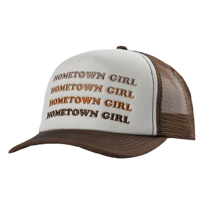 Trucker-style cap with ’HOMETOWN GIRL’ repeated in brown text on a white front panel and brown mesh back.