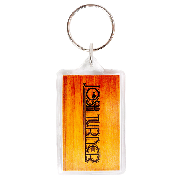 Keychain with a rectangular orange-tinted plastic tag displaying the word ’FORETURNER’.