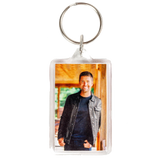 Keychain with a photo insert displaying a smiling person in casual attire.