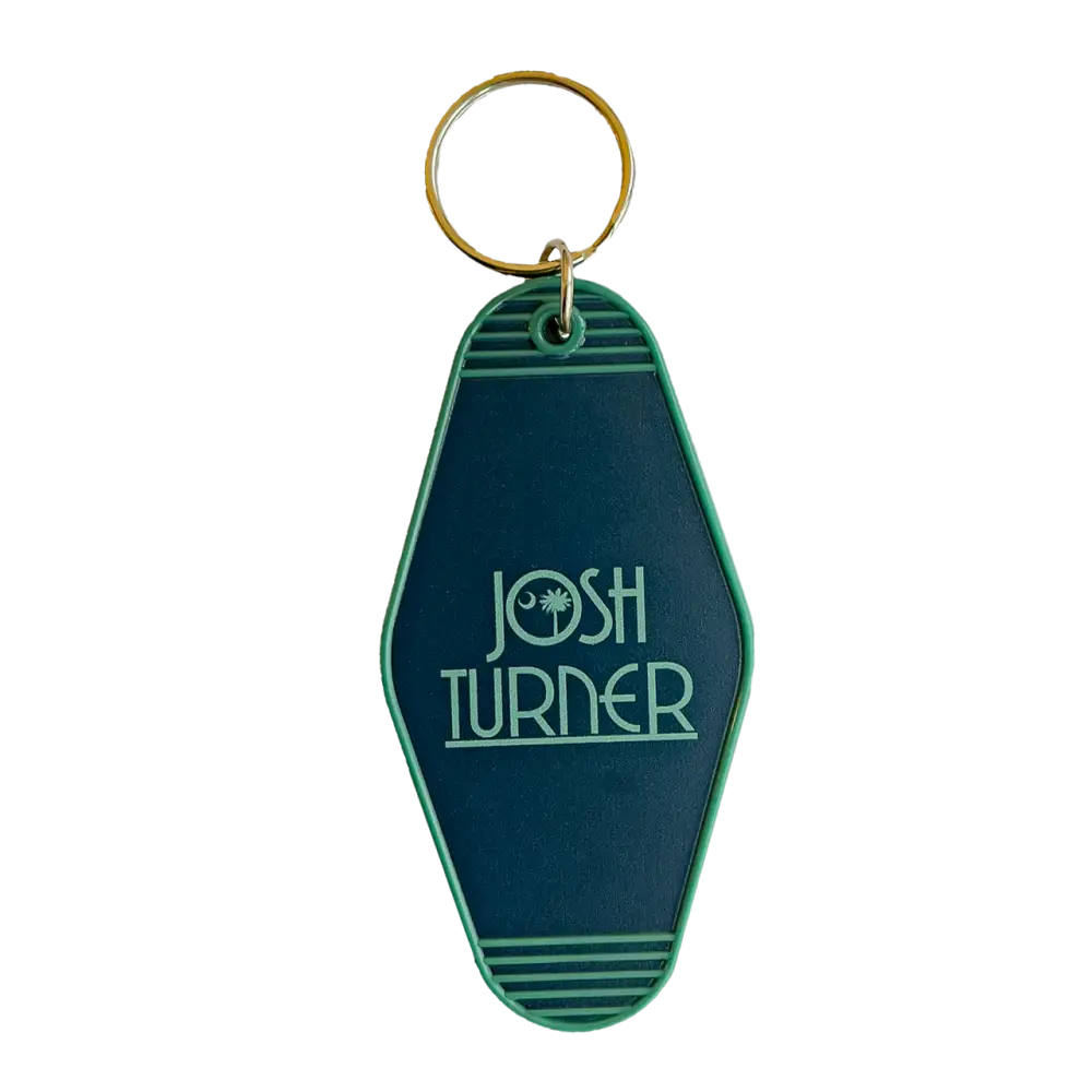 Retro-style green keychain tag with ’JOSH TURNER’ printed on it.