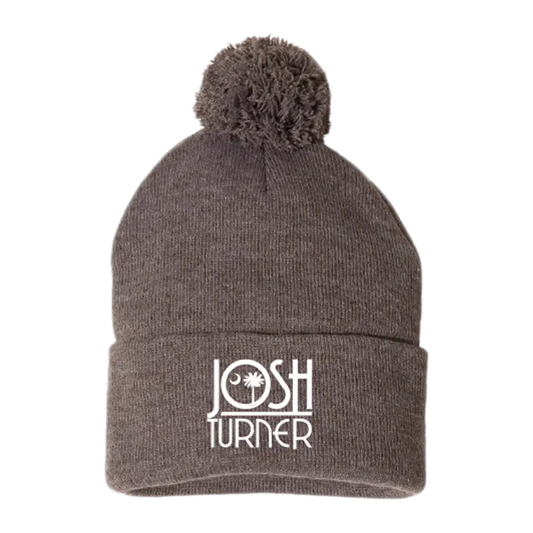 Gray knit beanie with a pom-pom and ’JOSH TURNER’ embroidered on the cuff.