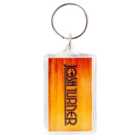 Keychain with a rectangular orange-tinted plastic tag displaying the word ’FORETURNER’.