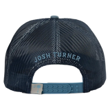 Dark navy mesh trucker hat with ’josh turner’ embroidered in light blue thread and a matching teal plastic adjustable strap featuring a beige tag with a pale blue palmetto tree logo.