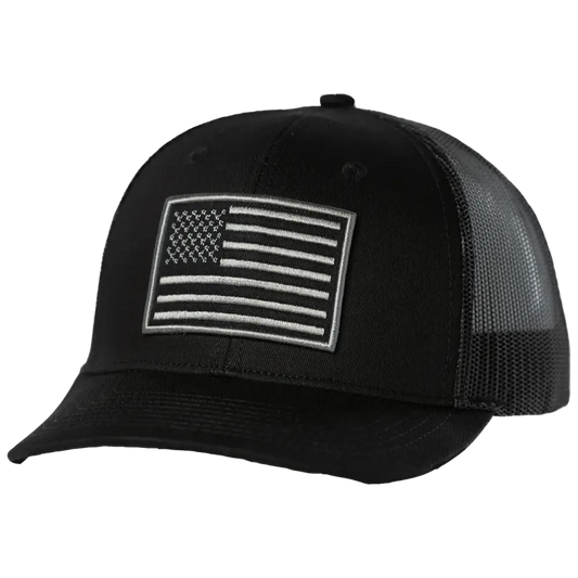 Black trucker hat with a white embroidered american flag patch on the front.