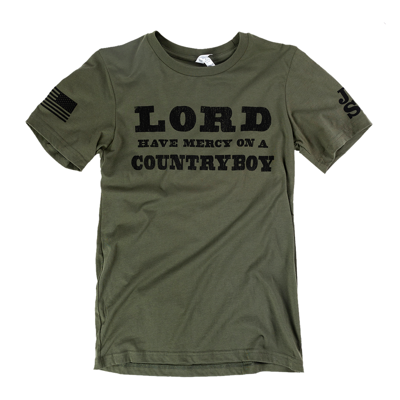 Olive green t-shirt with black text reading ’LORD HAVE MERCY ON A COUNTRYBOY’ and small flag patches on the sleeves.