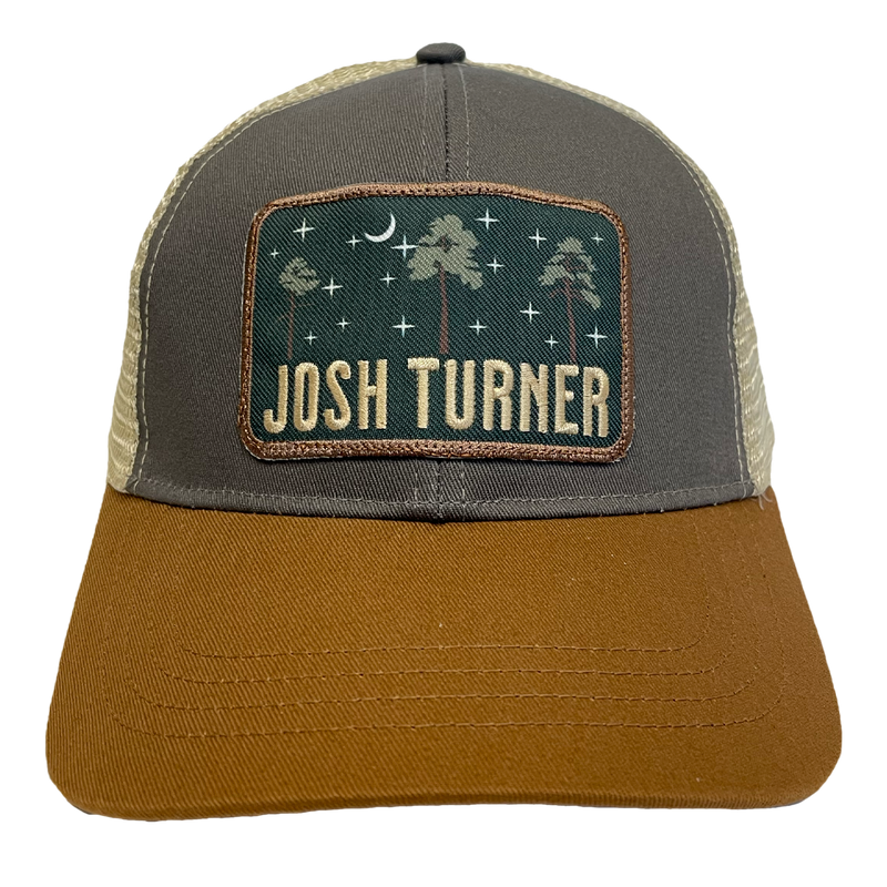 Trucker-style baseball cap with a ’Josh Turner’ patch featuring a nighttime forest scene.