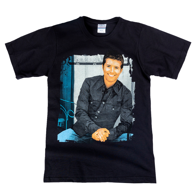 Black t-shirt with a printed photograph of a smiling man in a dark shirt on the front.