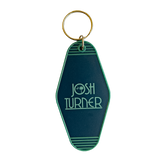 Retro-style green keychain tag with ’JOSH TURNER’ printed on it.